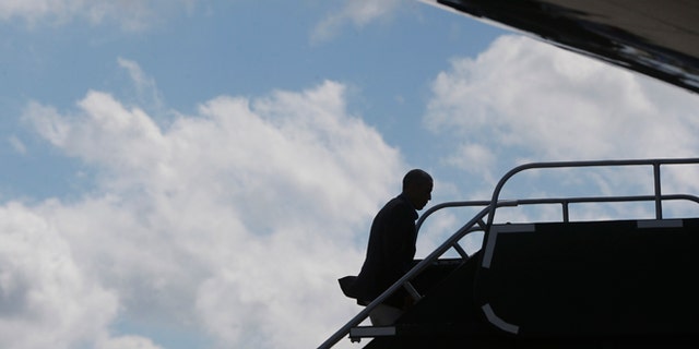President Barack Obama boards Air Force One in Milwaukee, Monday, Sept. 1, 2014.