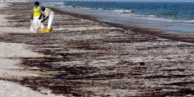 June 23: Crews work to clean up oil from the Deepwater Horizon oil spill washed ashore at Pensacola Beach in Pensacola, Fla.