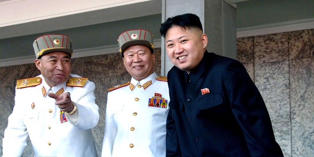 FILE: Undated: North Korean leader Kim Jong Un, (r.), with the Korean People's Army senior officers, preparing a satellite launch.