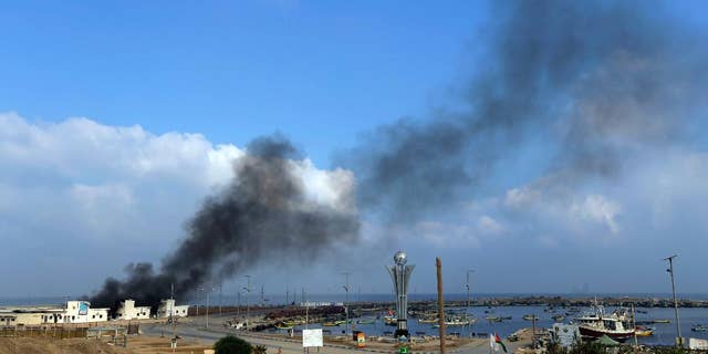 Smoke rises at the port in Gaza City, northern Gaza Strip, hit by an Israeli strike, Tuesday, July 29, 2014. According to Palestinians, the storage area at the port where the fishermen keep their nets and equipment was hit. Early Tuesday, Israel warplanes struck a series of targets in Gaza City, including Hamas leader Ismael Haniyeh's house and government offices, while Gaza's border area with Israel was hit by heavy tank shelling. (AP Photo/Lefteris Pitarakis)