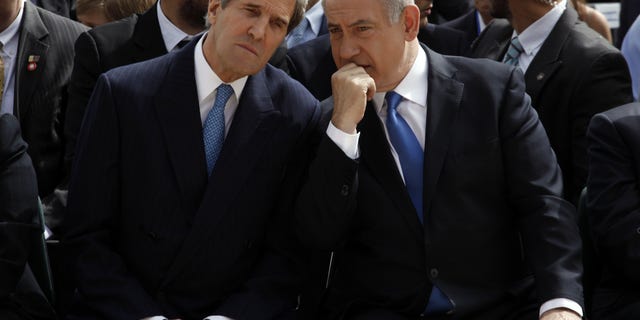 FILE - In this Monday, April 8, 2013 file photo, Israeli Prime Minister Benjamin Netanyahu, right, speaks with U.S. Secretary of State John Kerry during the annual ceremony marking Holocaust Remembrance Day at the Yad Vashem memorial in Jerusalem. On the surface, the Arab League’s new peace initiative offers Israel everything it ever dreamed of _ normal relations with an entire region that has long objected to the very existence of the Jewish state, and even the chance to keep some war-won land. But two weeks after Secretary of State John Kerry persuaded Arab leaders to reissue their 2002 offer with new incentives, Israel is maintaining a striking silence and critics are accusing Prime Minister Benjamin Netanyahu of tragically missing a historic opportunity. (AP Photo/Gali Tibbon, Pool)