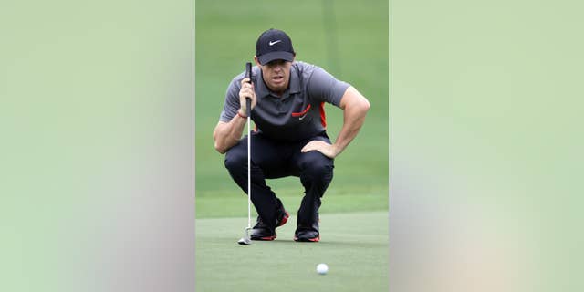 Rory McIlroy eyes his putt on the 18th green during the pro-am of the Wells Fargo Championship golf tournament at Quail Hollow Club in Charlotte, N.C., Wednesday, April 30, 2014. (AP Photo/Bob Leverone)
