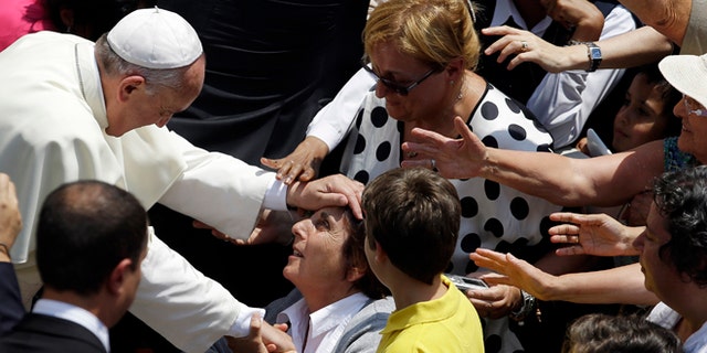 July 14, 2013: Pope Francis blesses a faithful after he delivered the Angelus prayer at the Pontiff's residence of Castel Gandolfo, near Rome.