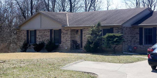 This Tuesday, March 17, 2015 photo shows the College Hill home where a three-month old baby was found murdered in Cincinnati. Police arriving in response to a 911 call found the baby decapitated and stabbed multiple times with a large chef's knife. Deasia Watkins, the 20-year-old mother, was found in bed covered with blood, Hamilton County prosecutor Joe Deters said. She was arrested and charged with aggravated murder. (AP Photo/The Cincinnati Enquirer, Amanda Rossmann) MANDATORY CREDIT; NO SALES