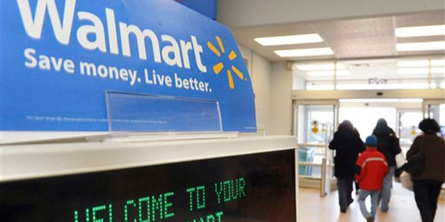 FILE - In this Feb. 17, 2009 file photo, shoppers leave a Wal-Mart store in Danvers, Mass. Wal-Mart has big hopes for a new effort to develop eco-ratings for products it sells _ one that goes far beyond its own stores. (AP Photo/Lisa Poole, file)