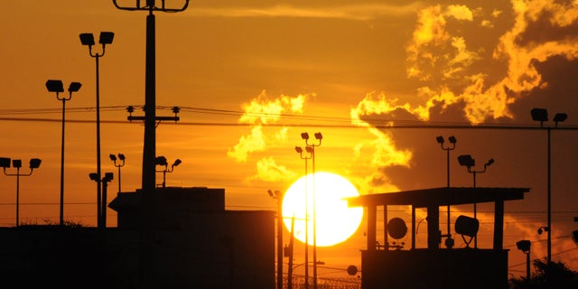 FILE - In this Oct. 18, 2012 file photo reviewed by the U.S. Department of Defense, towers overlooking a U.S. detention facility are silhouetted against a morning sunrise at Guantanamo Bay U.S. Naval Base, Cuba. A Republican-led Senate panel on Feb. 12, 2015, narrowly approved legislation that would bar most transfers of terror suspects from the U.S. prison at Guantanamo Bay, Cuba, a major roadblock in President Barack Obamas push to close the detention center.(AP Photo/Toronto Star, Michelle Shephard, File)