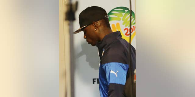 Italy forward Mario Balotelli walks away after the group D World Cup soccer match between Italy and Uruguay at the Arena das Dunas in Natal, Brazil, Tuesday, June 24, 2014. Uruguay won 1-0. Uruguay won 1-0. The four-time champion Italy is heading home after the group phase for a second time in four years. Head coach Cesare Prandelli and football federation president Giancarlo Abete both resigned moments after the match. (AP Photo/Antonio Calanni)