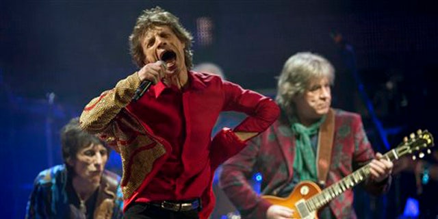 FILE - In this June 29, 2013 file photo Mick Jagger, center, Ronnie Wood, left, and Mick Taylor, of British rock band The Rolling Stones, perform on the Pyramid main stage at Glastonbury, England. The Rolling Stones on Tuesday, Nov. 19, 2013 announced theyâll be playing a gig March 22, 2014 at the Adelaide Oval in Australia. The band hasnât played the country since 2006. A news release says former member Taylor will be a special guest for the concert. (Photo by Joel Ryan/Invision/AP, File)