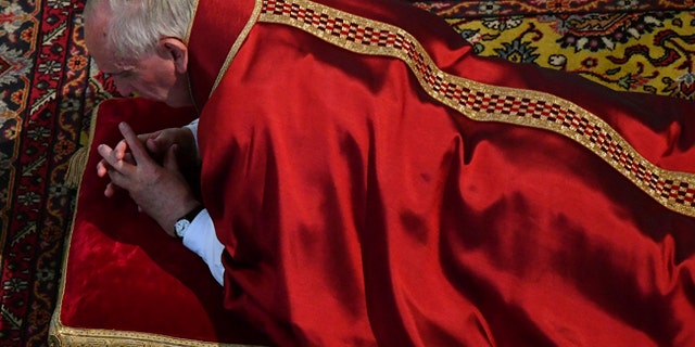 Pope Francis lies down in prayer during the Good Friday Passion of Christ Mass inside St. Peter's Basilica, at the Vatican, Friday, April 14, 2017. Pope Francis began the Good Friday service at the Vatican with the Passion of Christ Mass and hours later will go to the ancient Colosseum in Rome for the traditional Way of the Cross procession. (Alberto Pizzoli/Pool Photo via AP)