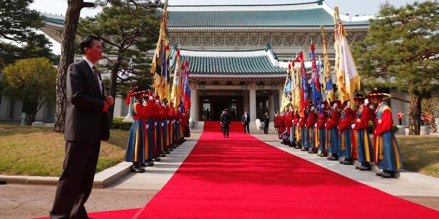 In this April 25, 2014, photo, a security official stands at the Blue House in Seoul, South Korea, before an official welcoming ceremony. South Korea said Wednesday, April 27, 2016, that North Korea has built a half-size mock-up of the South's presidential palace at a firing range in what looked like preparations for a live-fire drill. (AP Photo/Charles Dharapak)