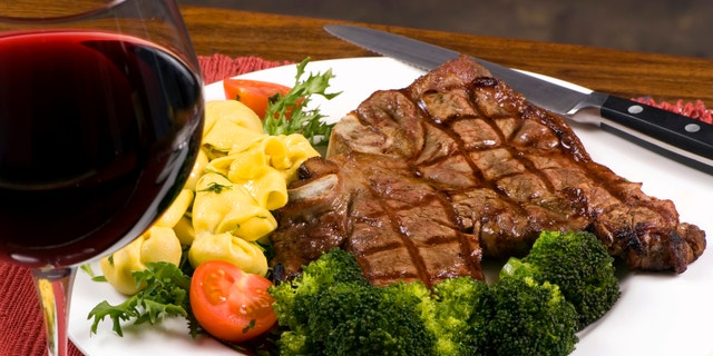 A mouth watering porterhouse steak with fresh vegetables and pasta