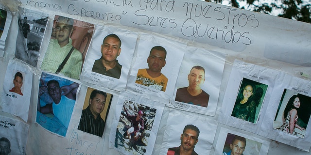 A banner with photos of several missing miners hangs on a tree near Tumeremo, Venezuela, March 8, 2016.