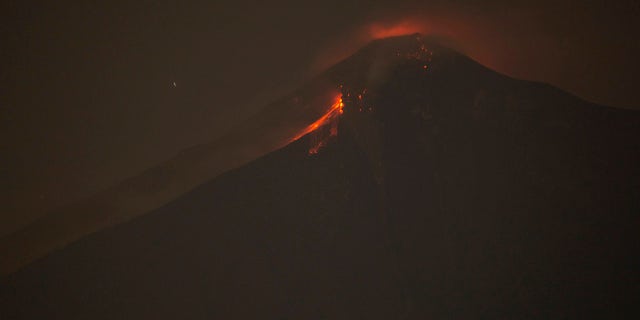 In this image taken with a long exposure, the Volcan de Fuego, or Volcano of Fire, spews hot molten rock from its crater in Alotenango, Guatemala.