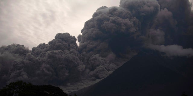 Volcan de Fuego, or Volcano of Fire, blows outs a thick cloud of ash, as seen from Alotenango, Guatemala.