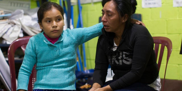 Fidelina Lopez, right, is consoled by her daughter Claudia in a shelter near the Volcan de Fuego or Volcano of Fire in Alotenango, Guatemala.