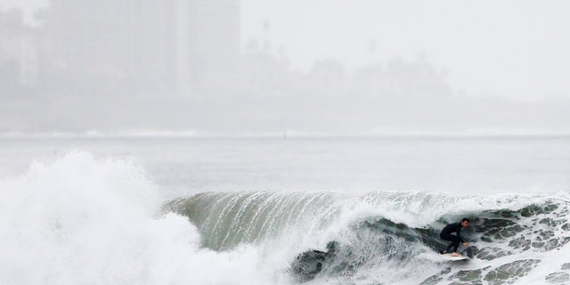 Dec. 16, 2014: A surfer rides a wave at Blacks Beach
