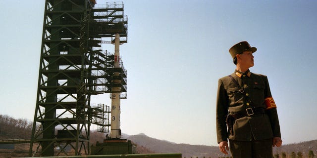 In this April 8, 2012 photo, North Korean soldiers stand guard in front of the country's Unha-3 rocket at Sohae Satellite Station in Tongchang-ri, North Korea. The Kwangmyongsong-3 satellite was launched on April 13, 2012 but failed to reach orbit. (AP Photo/David Guttenfelder)