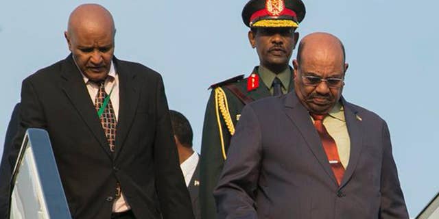 Sudan president Omar al-Bashir, right, arrives in Kigali, capital of Rwanda, Saturday, July 16, 2016. Al-Bashir arrived in Rwanda to attend a summit of African leaders, defying an international warrant of arrest after public assurances from Rwandan leaders that he would not be arrested. (AP Photo/Ssuuna katera)