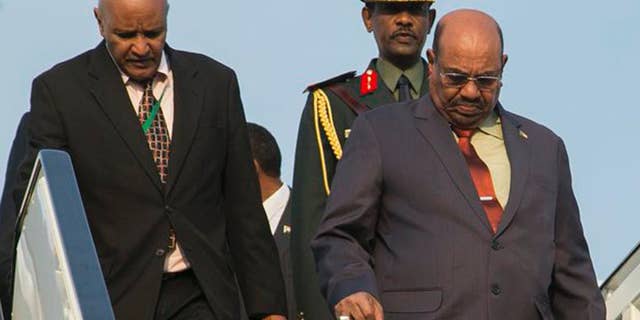 Sudan president Omar al-Bashir, right, arrives in Kigali, capital of Rwanda, Saturday, July 16, 2016. Al-Bashir arrived in Rwanda to attend a summit of African leaders, defying an international warrant of arrest after public assurances from Rwandan leaders that he would not be arrested. (AP Photo/Ssuuna katera)