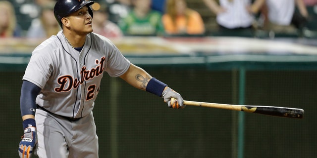 Detroit Tigers' Miguel Cabrera watches his ball after hitting a two-run home run off Cleveland Indians relief pitcher Rich Hill in the eighth inning of a baseball game, Wednesday, May 22, 2013, in Cleveland. The ball popped out of the glove of Cleveland Indians' Michael Bourn and bounced over the wall for a home run. Andy Dirks scored. (AP Photo/Tony Dejak)