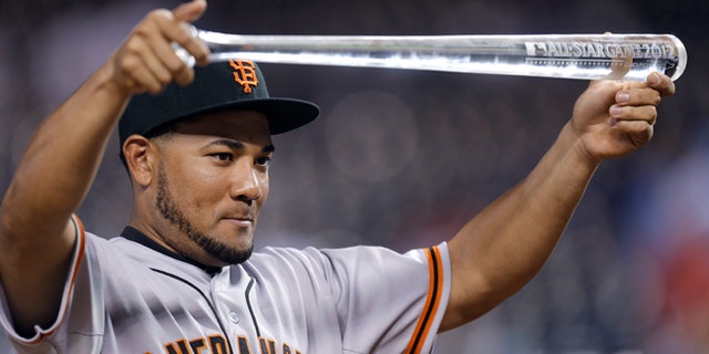 July 10, 2012: Melky Cabrera, of the San Francisco Giants, showing off his MVP trophy after the MLB All-Star baseball game in Kansas City, Mo.