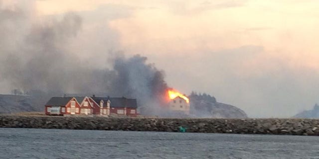 In this image taken from a rescue boat, buildings are seen on fire in Hasvaag, some 240 km north of Trondheim, Norway,  Tuesday, Jan. 28, 2014.  All of Hasvaag's 50-70 buildings have reportedly burned down. There have been no injuries, but all of the twenty people present have been evacuated. Many of the buildings are summer houses and cabins.  (AP Photo/NTB Scanpix, Redningsskoyta Harald V) NORWAY OUT