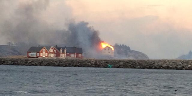 In this image taken from a rescue boat, buildings are seen on fire in Hasvaag, some 240 km north of Trondheim, Norway, Tuesday, Jan. 28, 2014. All of Hasvaag's 50-70 buildings have reportedly burned down. There have been no injuries, but all of the twenty people present have been evacuated. Many of the buildings are summer houses and cabins. (AP Photo/NTB Scanpix, Redningsskoyta Harald V) NORWAY OUT