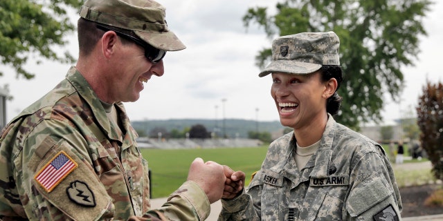 Cadet Simone Askew, of Fairfax, Va., right, talking with Brigade Tactical Officer Col. Brian Reed, has been selected first captain of the Corps of Cadets for the upcoming academic year at the U.S. Military Academy in West Point, NY, Monday, Aug. 14, 2017