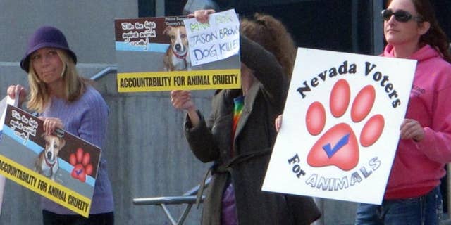 A half dozen animal rights activists protested Thursday, Oct. 16, 2014, outside Reno Justice Court where Jason Brown, 24, was to appear later in the day at a status hearing on charges accusing him of torturing and killing several dogs in July. Leaders of Nevada Voters for Animals are urging the maximum punishment if Brown is convicted of all seven counts, which could total more than 20 years in prison. (AP Photo/Scott Sonner).