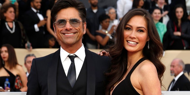 Actor John Stamos and Caitlin McHugh at the 24th Screen Actors Guild Awards.