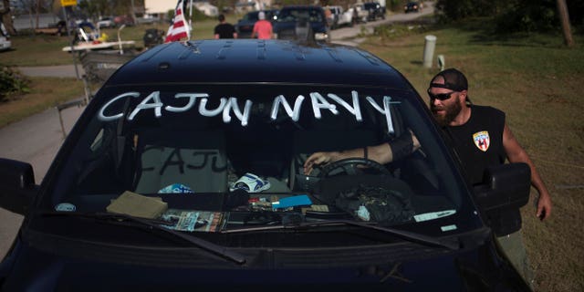 A volunteer with the Cajun Navy takes a break between clearing debris in the aftermath of Hurricane Irma on Chokoloskee Island, Florida, U.S. Sept. 12, 2017.