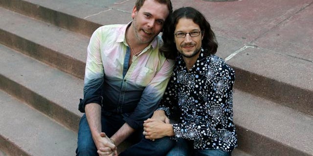 June 6, 2013: This file photo shows Dave Mullins, right, sitting for a portrait with his husband Charlie Craig, in Denver.