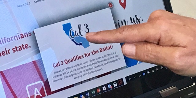 In this June 18 photo, venture capitalist Tim Draper points to a computer screen at his offices in San Mateo, Calif., showing that an initiative to split California into three states qualified for the ballot. Opponents of the initiative are asking the state Supreme Court to pull the measure from the ballot.