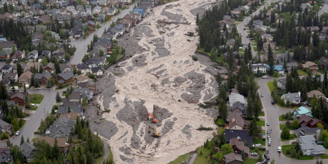 June 21, 2013: The flooded Cougar Creek runs through Canmore, Alberta.