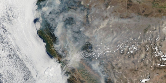 An image captured by NASA shows wildfires raging over California and Oregon.