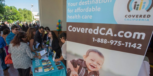 Oct. 1, 2013: People sign up for health insurance information at a Covered California event which marks the opening of the state's Affordable Healthcare Act, commonly known as Obamacare.