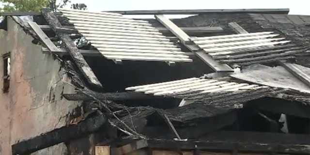 The home has a large section of roof missing from a fire.
