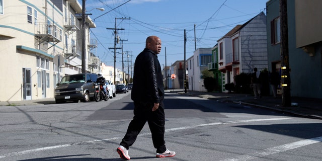Feb. 13, 2014: Ernest Morgan walks around his neighborhood in San Francisco.