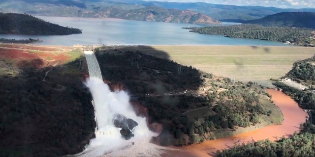 Water flows over an emergency spillway of the Oroville Dam in Oroville, Calif., on Feb. 10, 2017.
