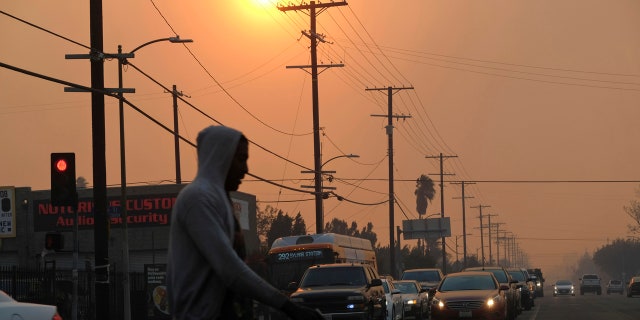 Smoke fills the sky near Hansen Dam in San Fernando Valley as a wildfire burns in the area in Los Angeles.