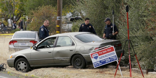 California Highway Patrol Officers inspect one of the vehicles involved when a gunman went on a shooting rampage at the Rancho Tehama Reserve, near Corning, Calif., Tuesday, Nov. 14, 2017.