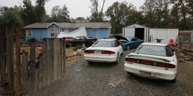 Cars are parked in front of the home of Kevin Janson Neal Wednesday, Nov. 15, 2017, in Rancho Tehama Reserve, Calif.