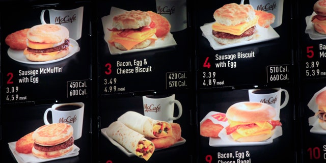FILE - In this Sept. 12, 2012 file photo, items on the breakfast menu, including the calories, are posted at a McDonald's restaurant in New York. Wondering how many calories are in that hamburger? Chain restaurants still don't have to tell you, despite a six year-old law requiring calorie labels. The Food and Drug Administration said earlier this month that it will delay menu labeling rules, again, until next year. Pushback from supermarkets and convenience stores that will be required to put calorie labels on take-out foods have slowed the process. (AP Photo/Mark Lennihan, File)