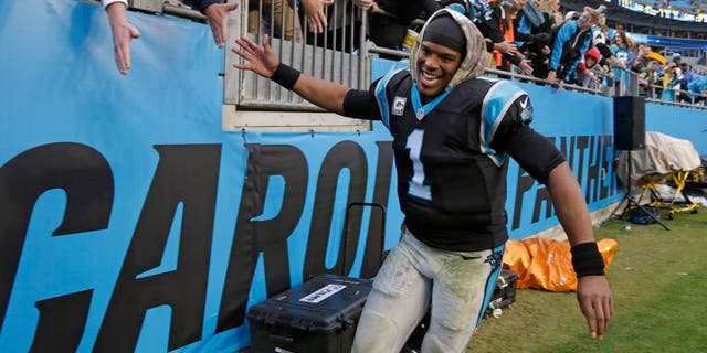 Carolina Panthers' Cam Newton (1) celebrates with fans after an NFL football game against the Green Bay Packers in Charlotte, N.C., Sunday, Nov. 8, 2015. The Panthers won 37-29. (AP Photo/Bob Leverone)