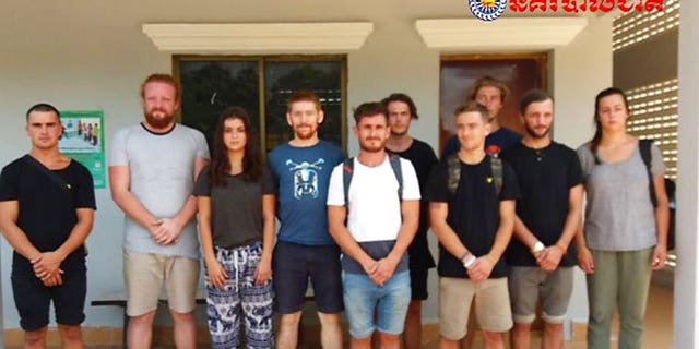 In this photo dated Jan. 27, 2018, issued by Cambodian National Police, a group of foreigners stand after they were arrested for "dancing pornographically" at a party in Siem Reap town, near the country's famed Angkor Wat temple complex.