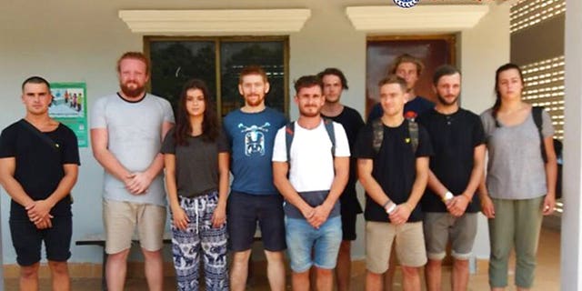 In this photo dated Jan. 27, 2018, issued by Cambodian National Police, a group of foreigners stand after they were arrested for "dancing pornographically" at a party in Siem Reap town, near the country's famed Angkor Wat temple complex.