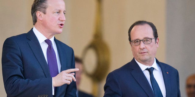 May 28, 2015: Britain's Prime Minister David Cameron, left, leaves with French President Francois Hollande, after their meeting, at the Elysee Palace in Paris. (AP)