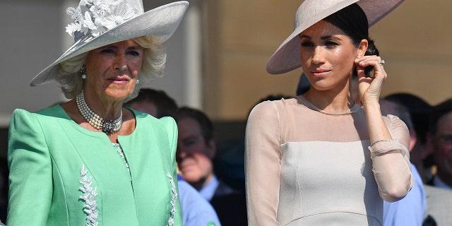Meghan, the Duchess of Sussex, right, stands with Camilla, the Duchess of Cornwall, during a garden party at Buckingham Palace in London, Tuesday May 22, 2018. The event is part of the celebrations to mark the 70th birthday of Prince Charles.