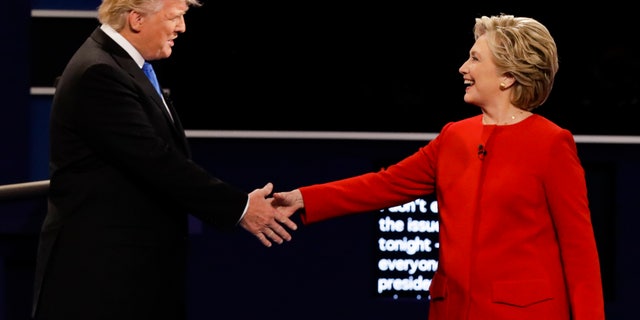 FILE -- Sept. 26, 2016: Republican presidential nominee Donald Trump and Democratic presidential nominee Hillary Clinton shake hands during the presidential debate at Hofstra University in Hempstead, N.Y.