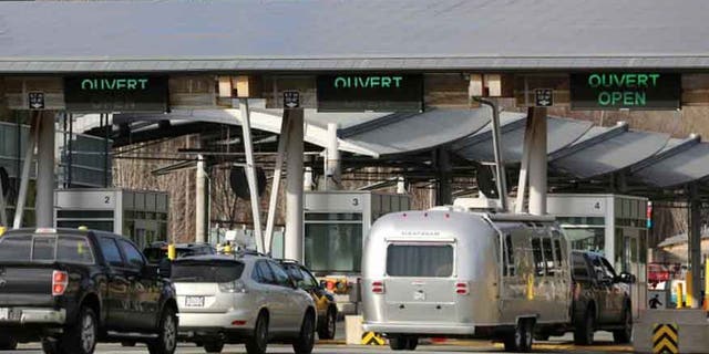 Cars enter lanes for Canada customs and border inspection after arriving from the United States to Surrey, British Columbia.